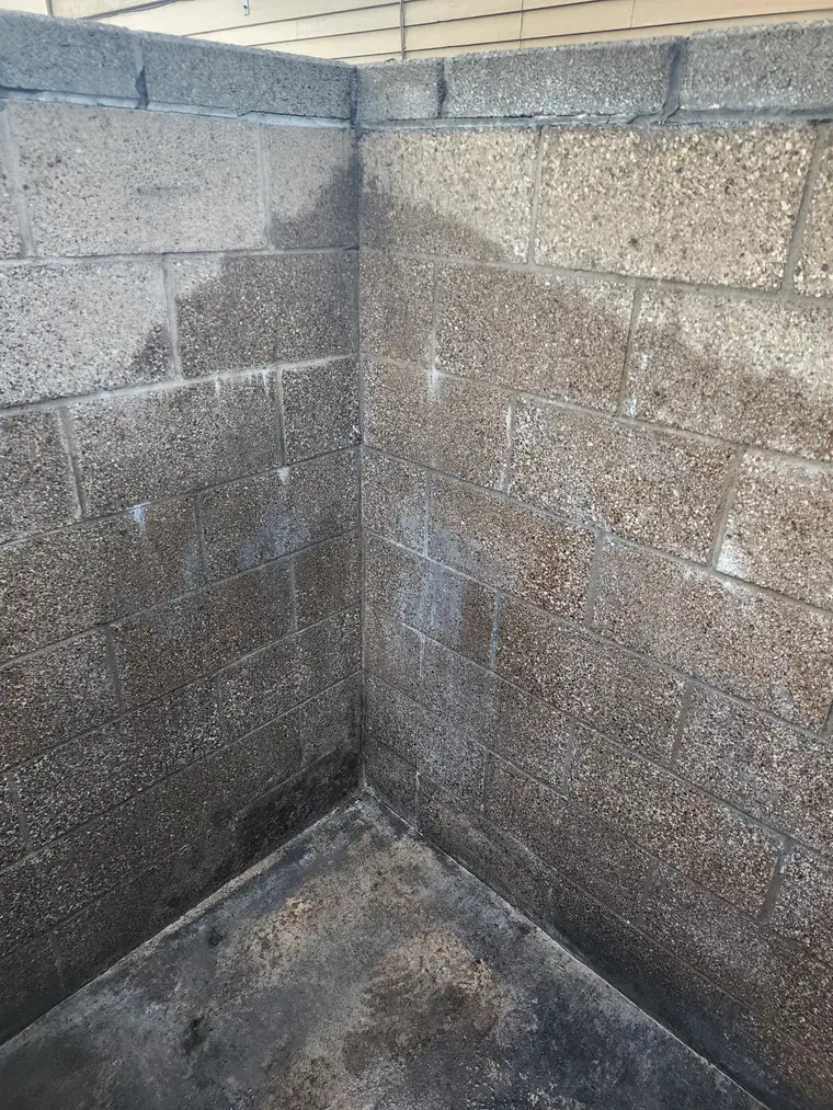 Dumpster enclosure wall cleaned after pressure washing at a restaurant in Bend, Oregon