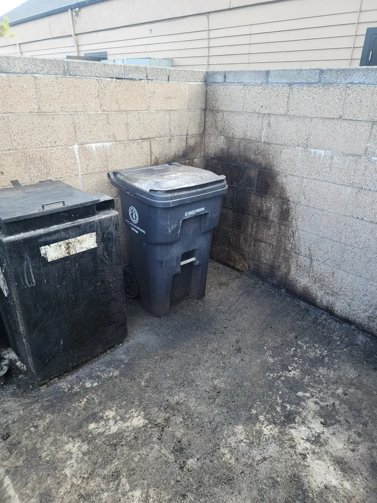 Dumpster enclosure wall stained with grime before pressure washing at a restaurant in Bend, Oregon