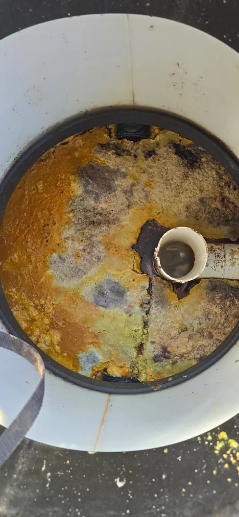 Grease trap full of hardened FOG before cleaning at a restaurant in Bend, Oregon