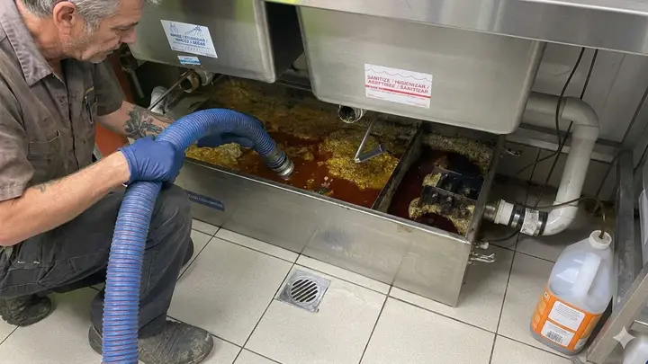 Grease Trap Cleaning in Bend, Oregon Technician servicing an outdoor grease interceptor at a Bend, Oregon restaurant
