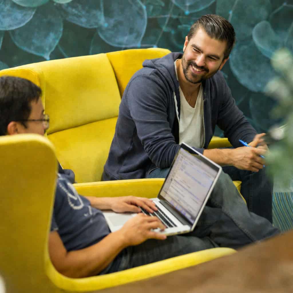 Professionals relaxing in a clean modern office lounge maintained by Maid Clean Janitorial Services in Bend, Oregon